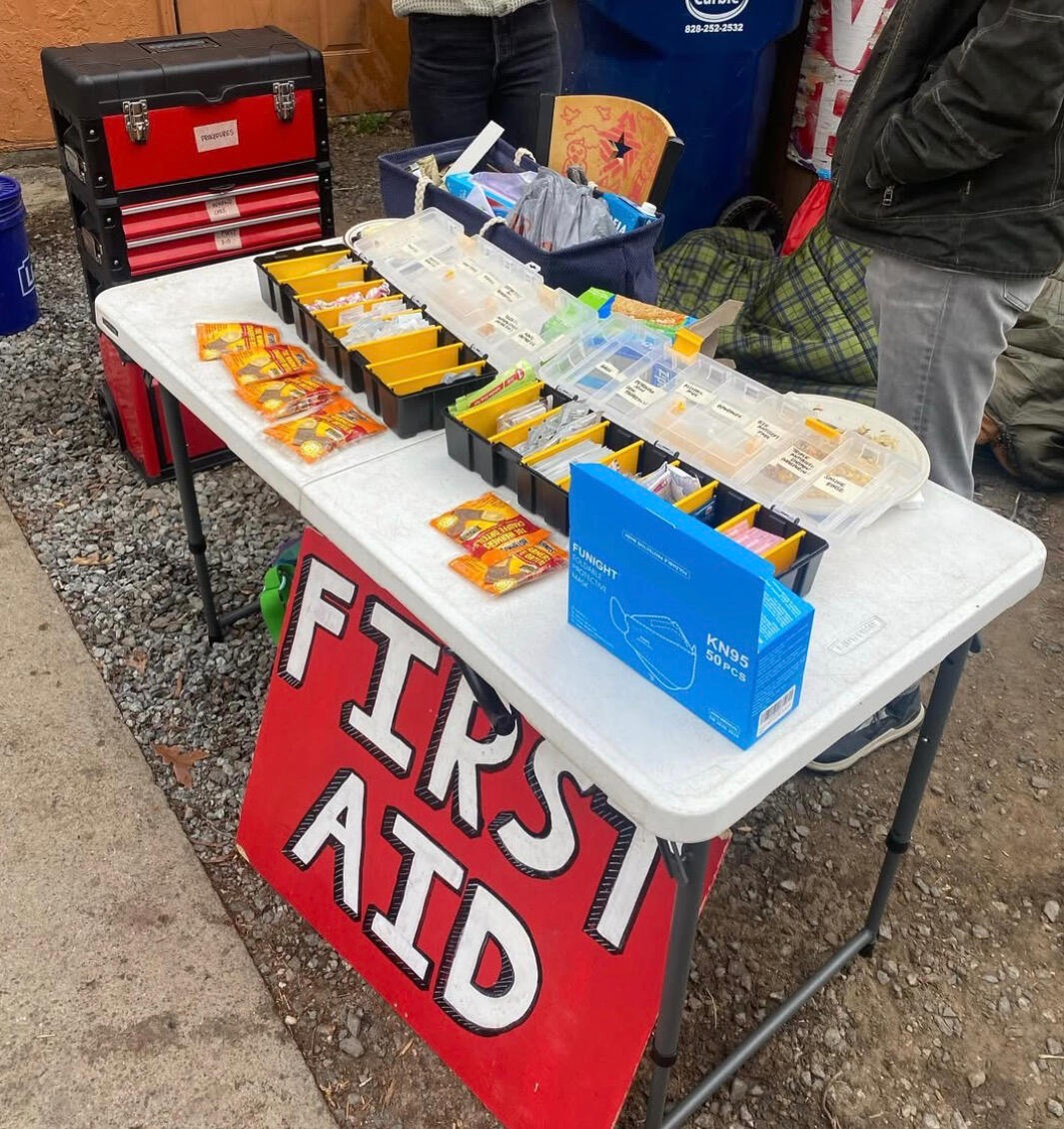 the text Mutual Aid Wellness Collective over an anatomical red heart in a black circle